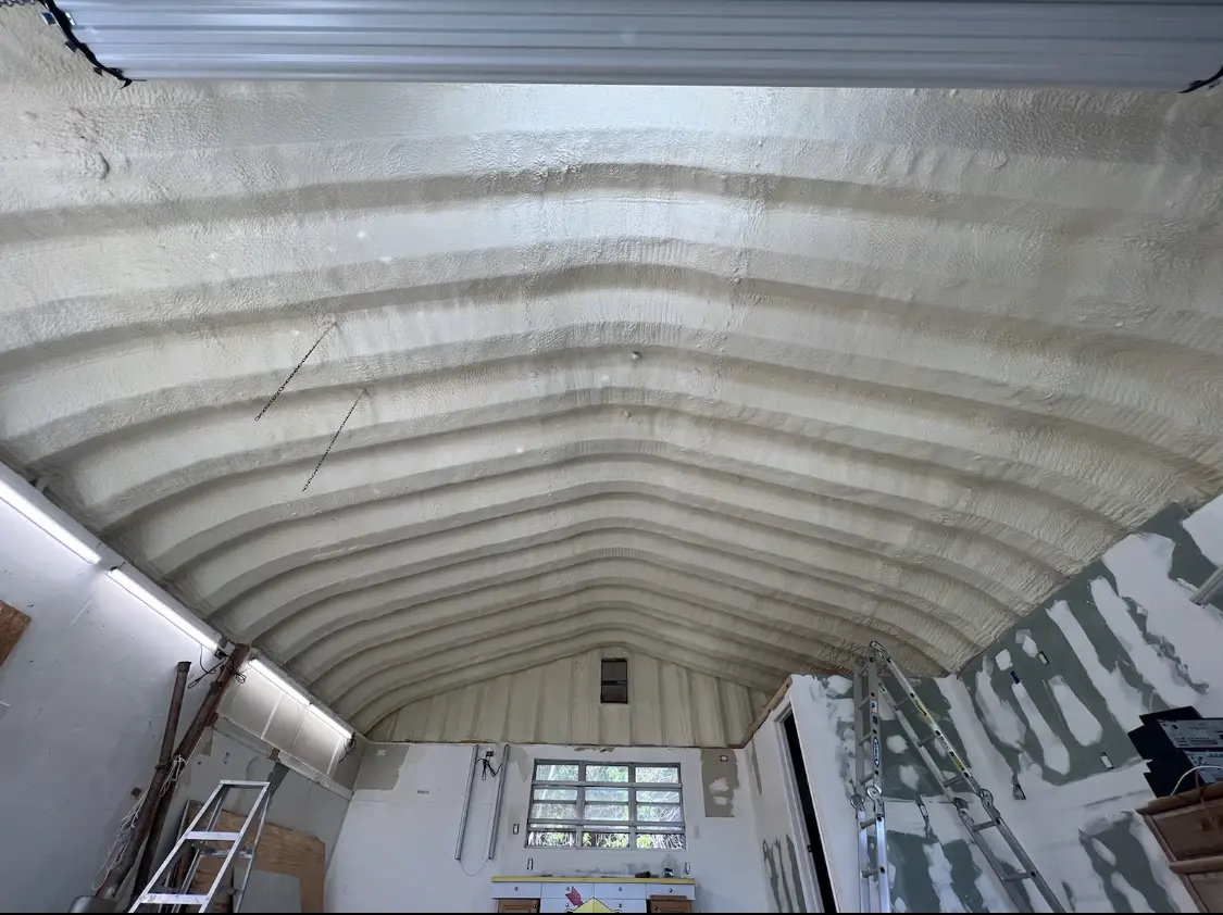 Spray polyurethane foam applied to the underside of a metal roof deck in Iowa Colony